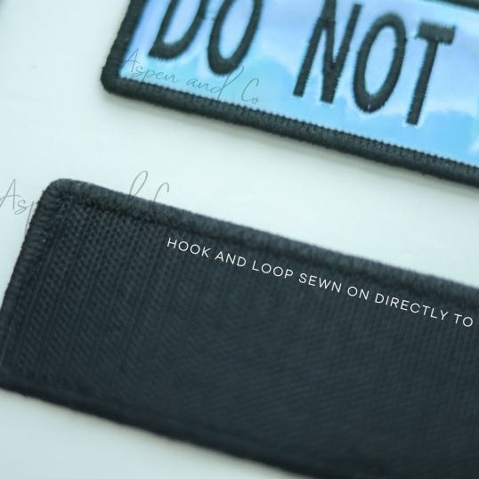 Close-up image of the hook side of a holographic embroidered dog patch, showing the hook-and-loop fastener for easy attachment to collars, harnesses, vests, or capes.