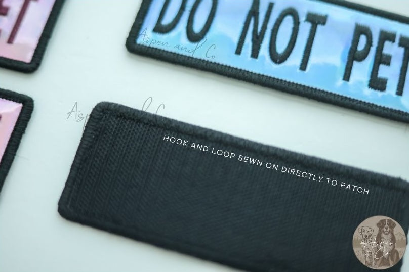 Close-up image of the hook side of a holographic embroidered dog patch, showing the hook-and-loop fastener for easy attachment to collars, harnesses, vests, or capes.