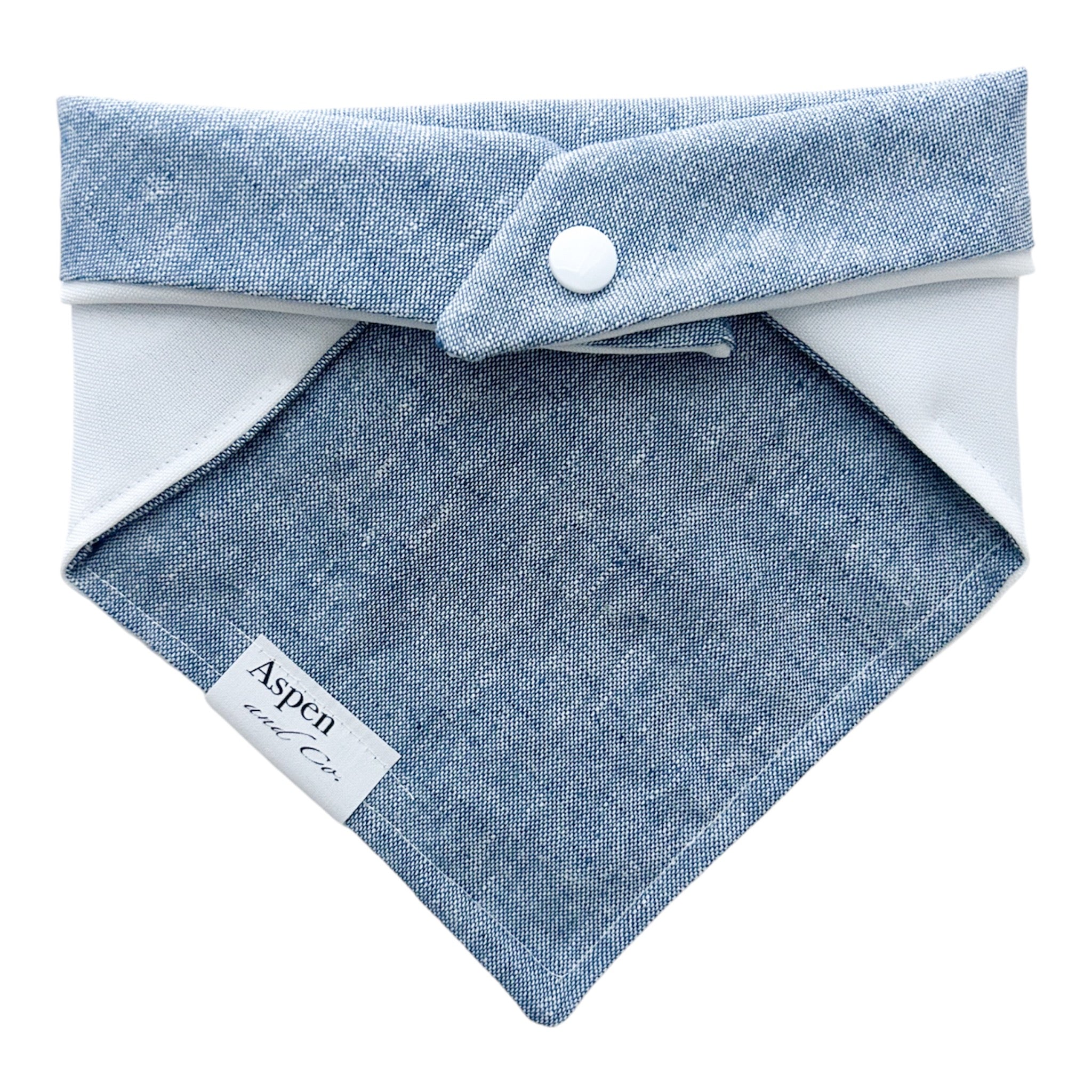 Back of dog bandana showing solid blue linen fabric with no embroidery and snaps to securely fasten around your pet’s neck.