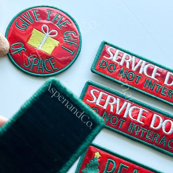 Set of embroidered service dog patches and reactive dog patches showing hook backing