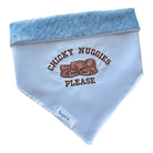 White embroidered dog bandana with the phrase “chicky nuggets please,” shown with blue linen backing for a stylish, reversible look.