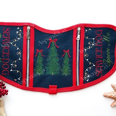 Navy blue and red embroidered Christmas Service Dog vest with holiday trees and lights, dual zipper pockets, and SERVICE DOG Ignore Me text on both sides