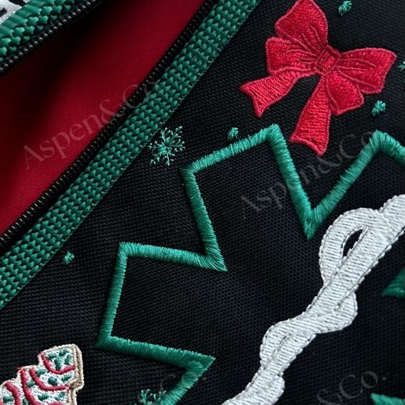 Interior view of the service dog vest’s lined pockets, showing zipper and festive holiday stitching.