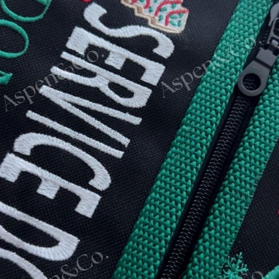 Fully lined zippered pockets of the Christmas service dog vest with black base and holiday detailing.