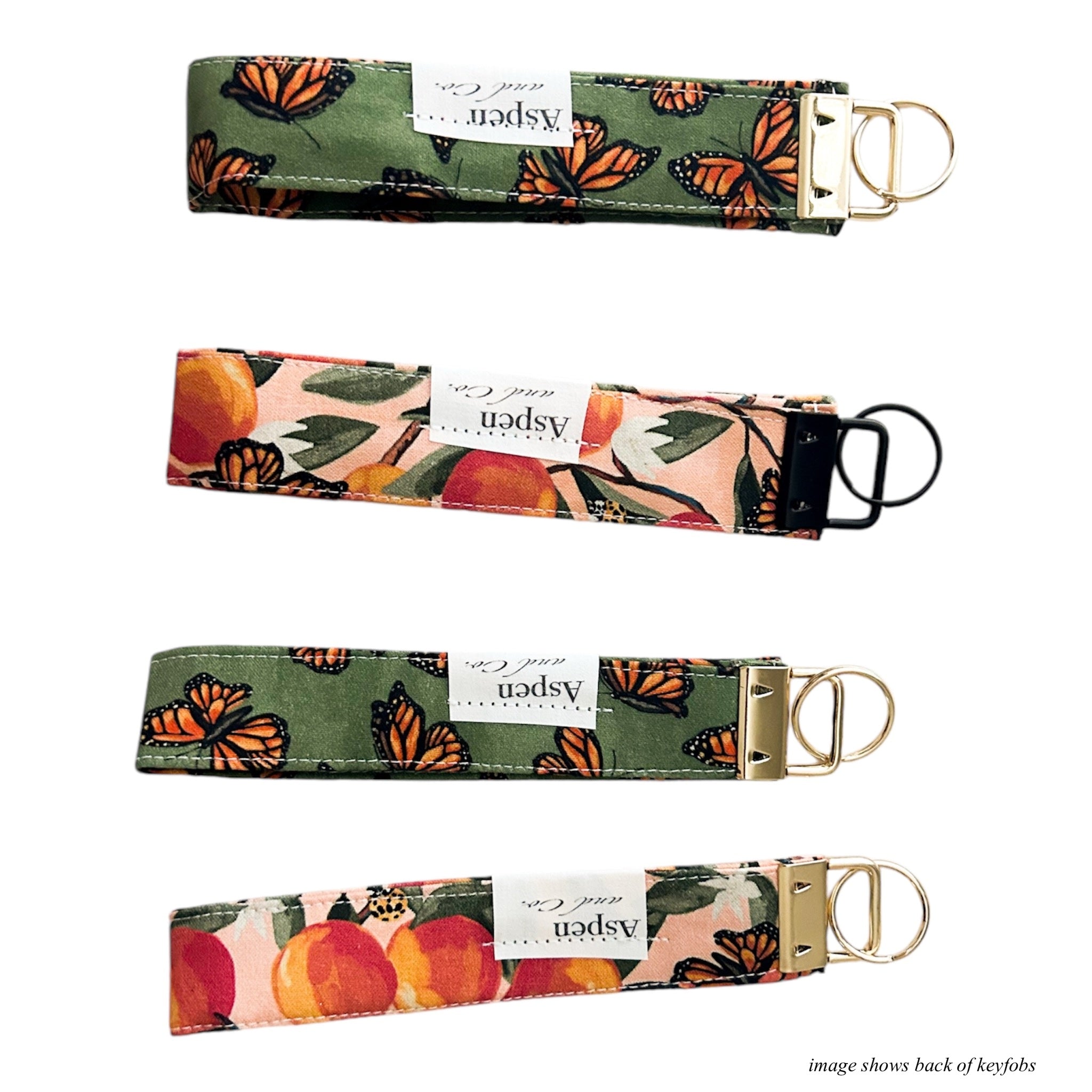 Backside of monarch butterfly key fob wristlets showing Aspen and Co. brand tag.