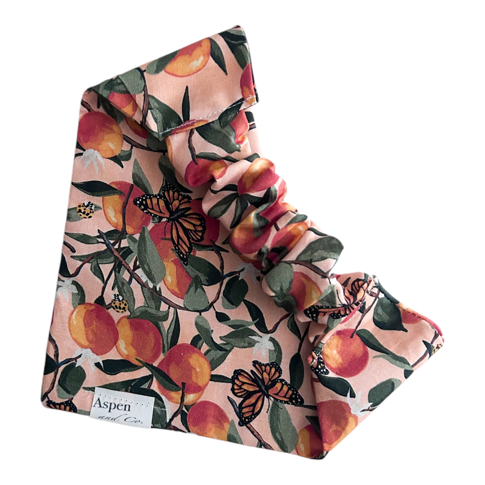 Slip-on dog bandana with elastic scrunchie collar and slide-on neck opening visible.