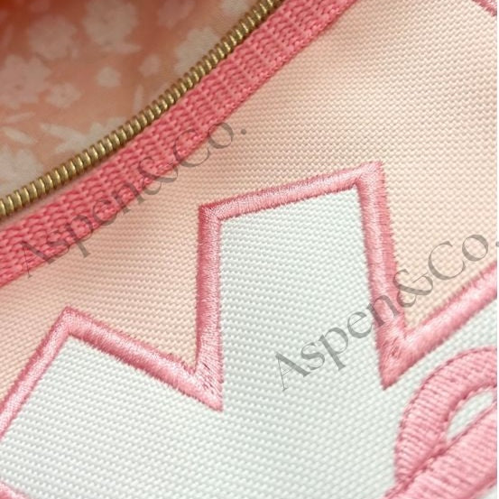 Close up of fully lined zippered pockets, showing coordinating floral print, designed by Aspen and Co.