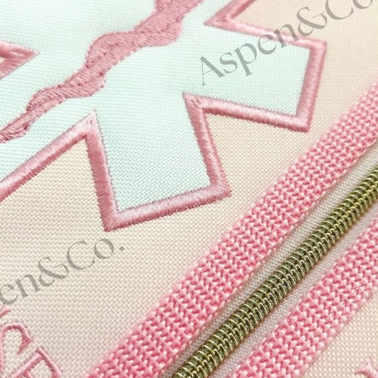 Close up of pink floral service dog vest with gold zippers, and dual side pockets. Embroidered floral design. Custom-fitted with straps and durable wipeable backing. Limited edition design from Aspen & Co.