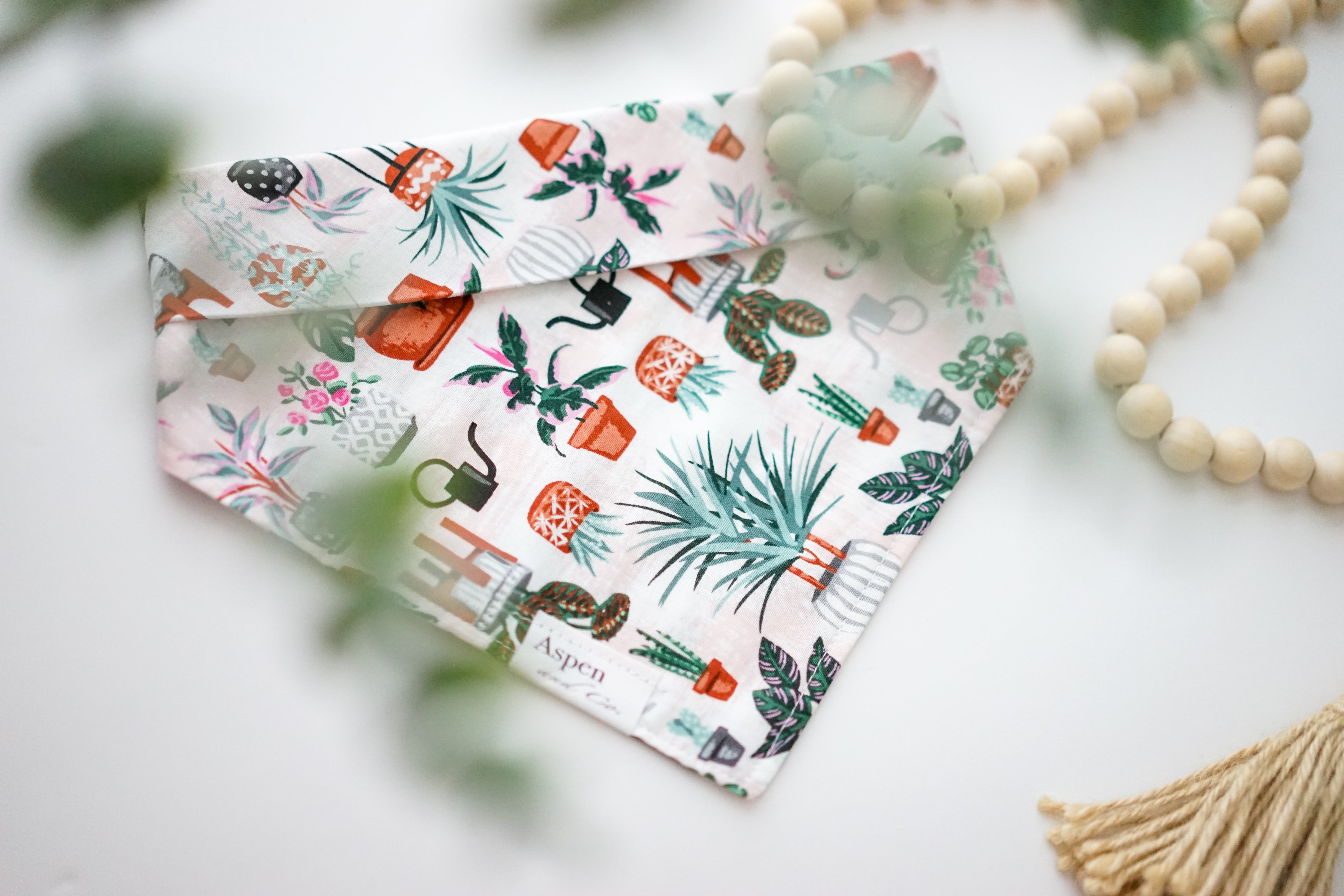 houseplants dog bandana featuring assorted houseplants in complementary colors made of soft lightweight cotton. This dog bandana is a snap on dog bandana and can be custom made and personalized with your dog's name.