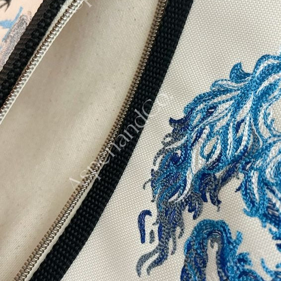 Close-up of a service dog vest pocket with blue dragon design.