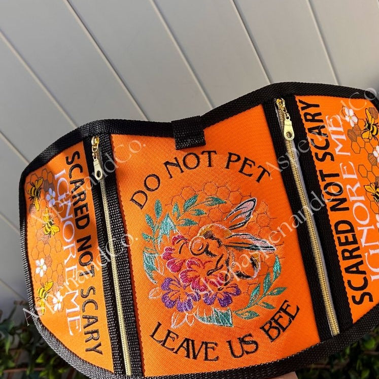 Reactive dog vest embroidered with bee and nature elements.