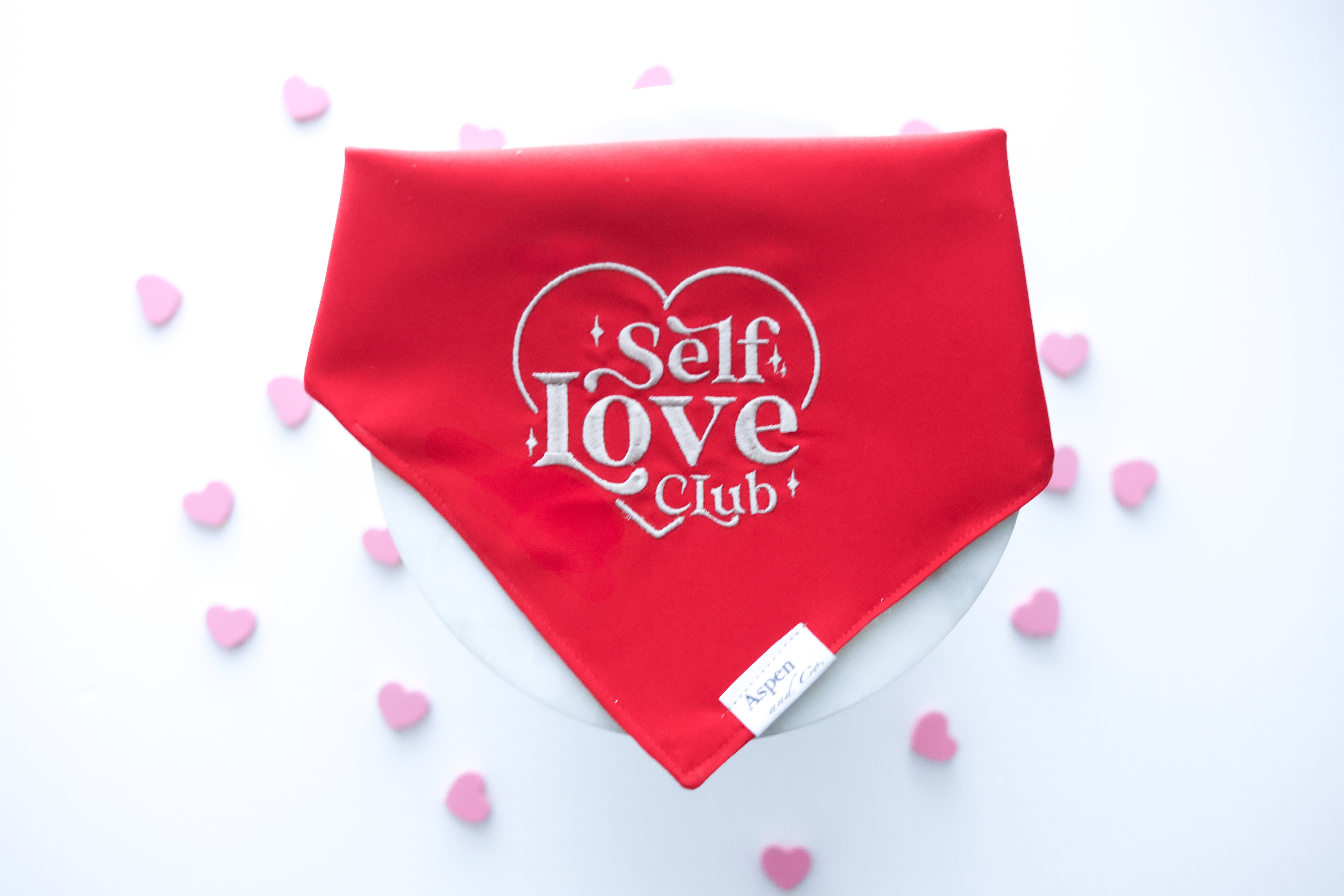 SEO-optimized image alt text:
Cool-toned red dog bandana with beige embroidery reading “Self Love Club” inside a heart shape; perfect for mental health awareness and everyday wear.