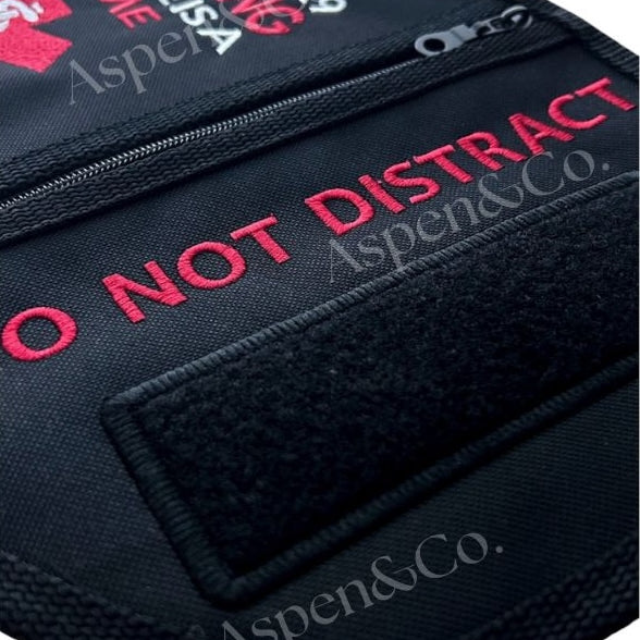 Close-up angle of the Aspen & Co. Working K9 vest showing the detailed embroidery and a 6x2" hook and loop patch panel labeled as space for optional add-on patches. Highlights high-stitch quality and reinforced zipper seams.