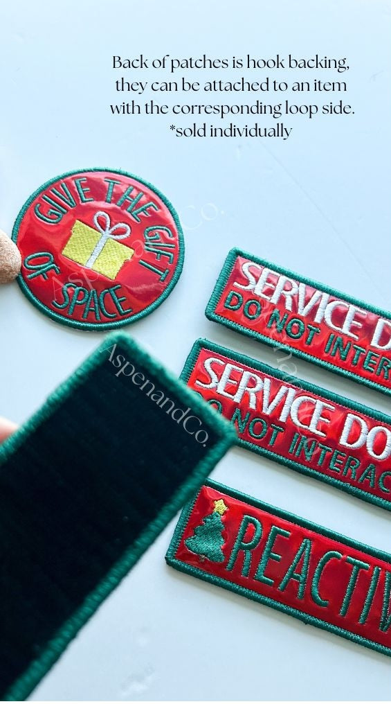 Set of embroidered service dog patches and reactive dog patches showing hook backing