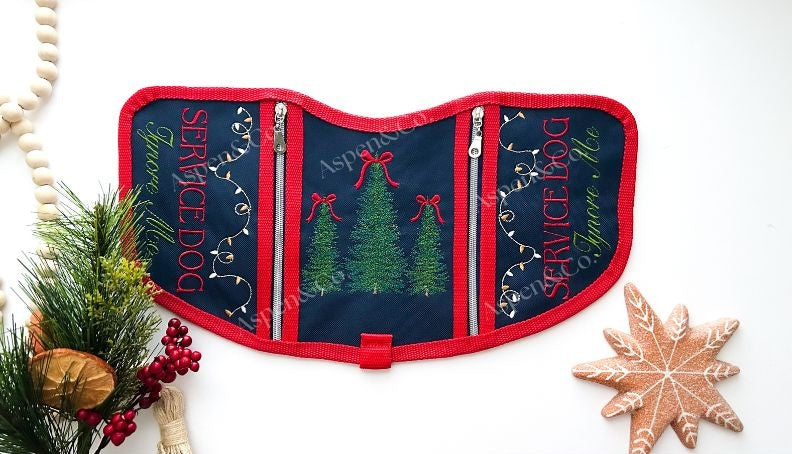 Navy blue and red embroidered Christmas Service Dog vest with holiday trees and lights, dual zipper pockets, and SERVICE DOG Ignore Me text on both sides