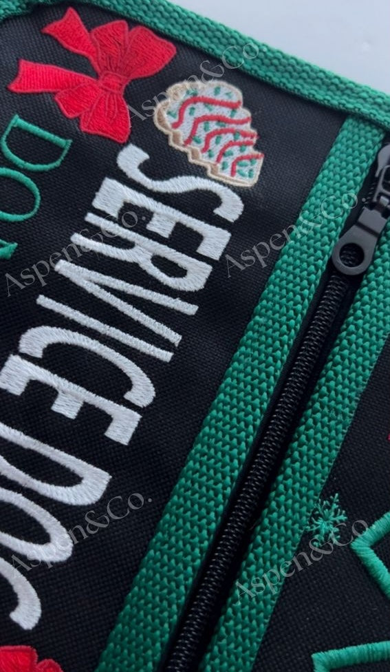 Fully lined zippered pockets of the Christmas service dog vest with black base and holiday detailing.