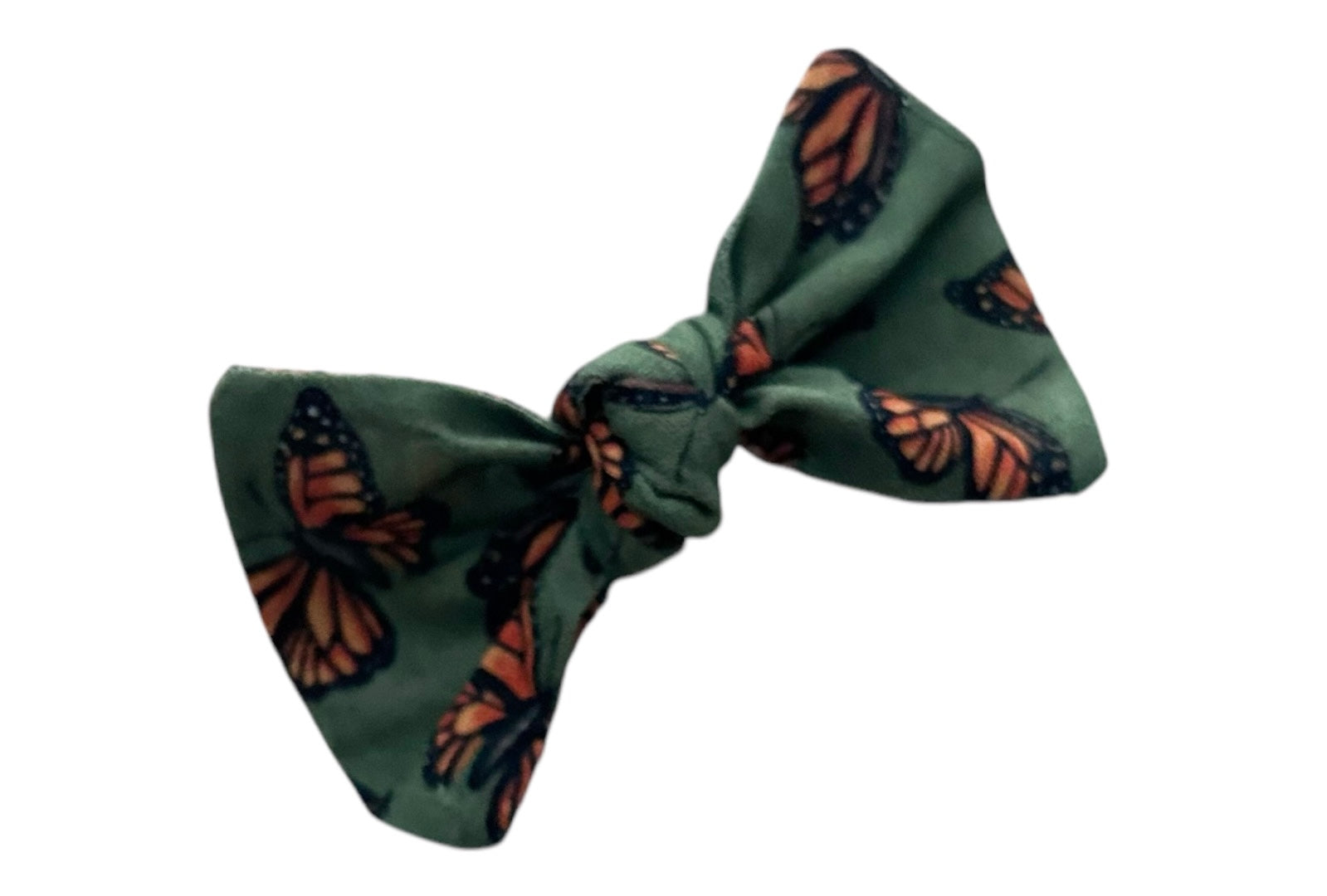 Olive-colored alligator clip hair bow with assorted monarch butterfly print, designed to accessorize dog bandanas