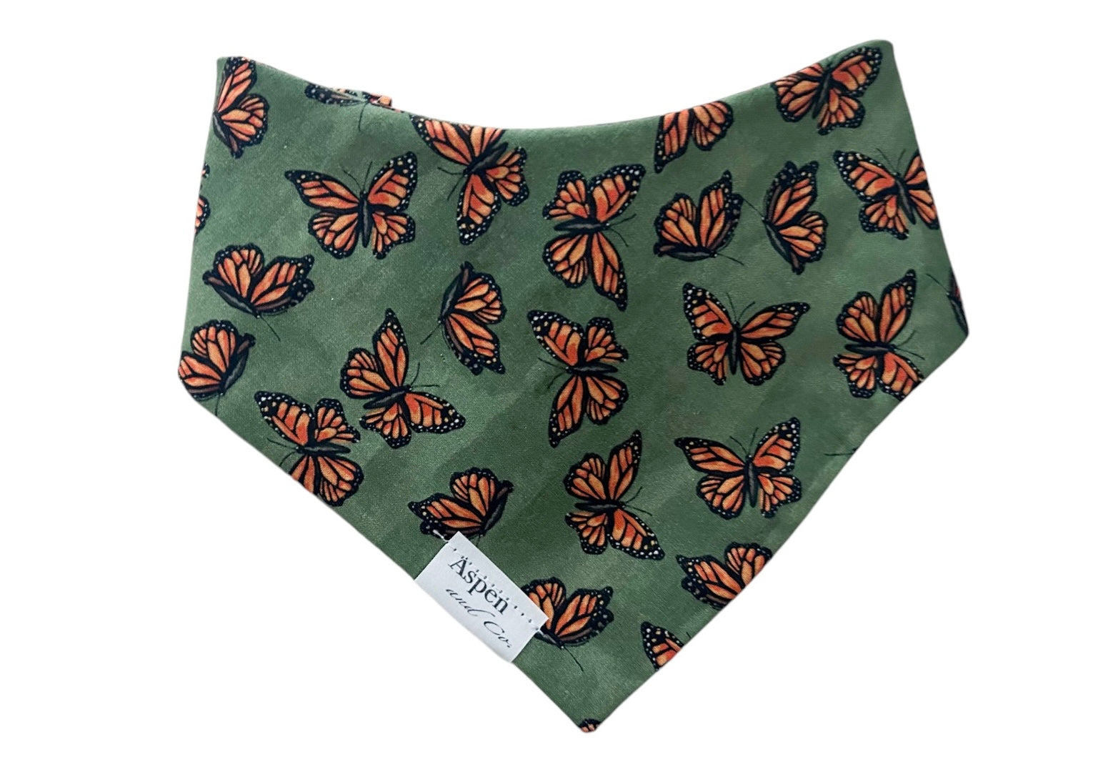 Close-up of olive scrunchie slide-on dog bandana featuring curved neckline and monarch butterfly print