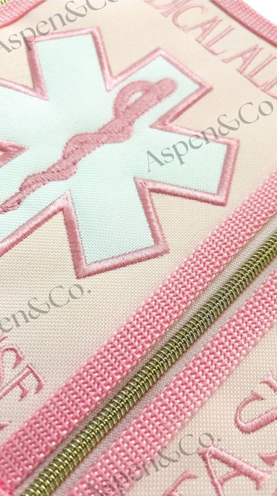 Close up of pink floral service dog vest with gold zippers, and dual side pockets. Embroidered floral design. Custom-fitted with straps and durable wipeable backing. Limited edition design from Aspen & Co.