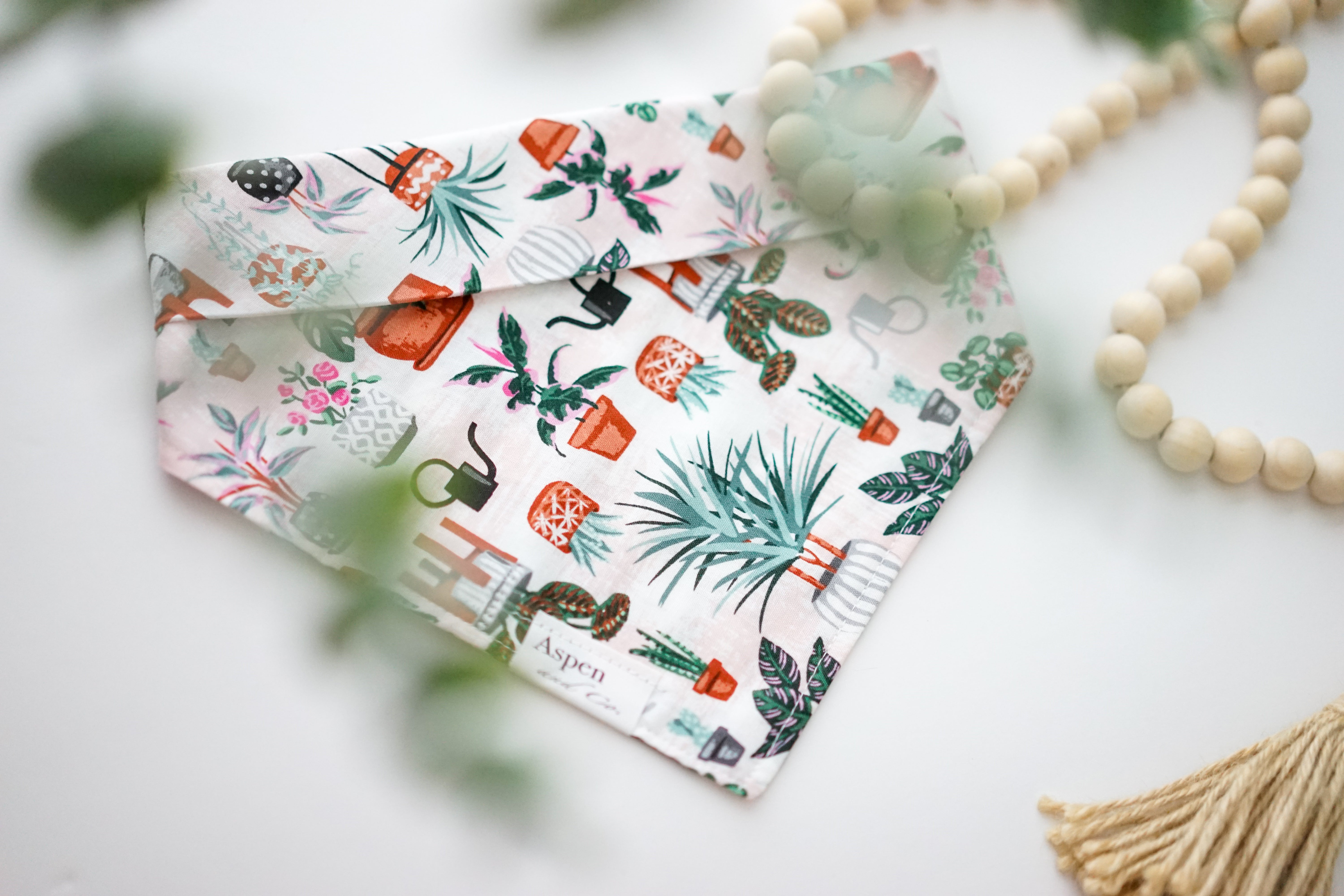 houseplants dog bandana featuring assorted houseplants in complementary colors made of soft lightweight cotton. This dog bandana is a snap on dog bandana and can be custom made and personalized with your dog's name.