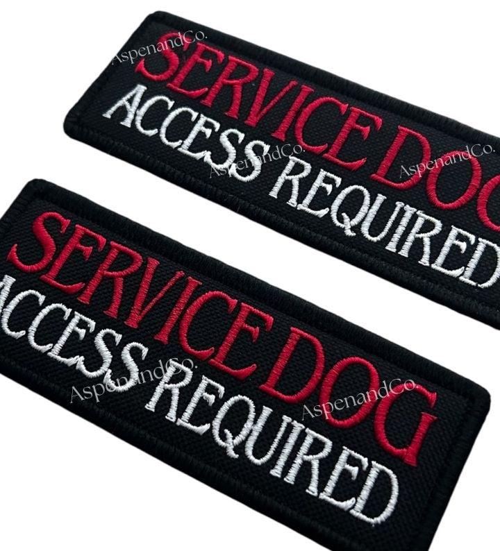 Two black patches with 'Service Dog Access Required' text in red and white on a white background.