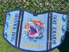 Service dog vest with shark design and text on a green background