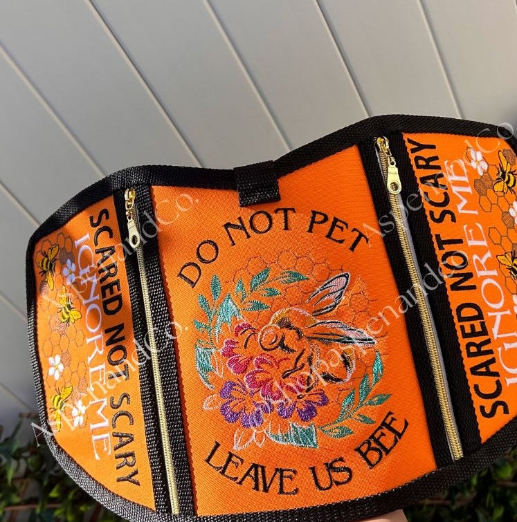 Reactive dog vest embroidered with bee and nature elements.