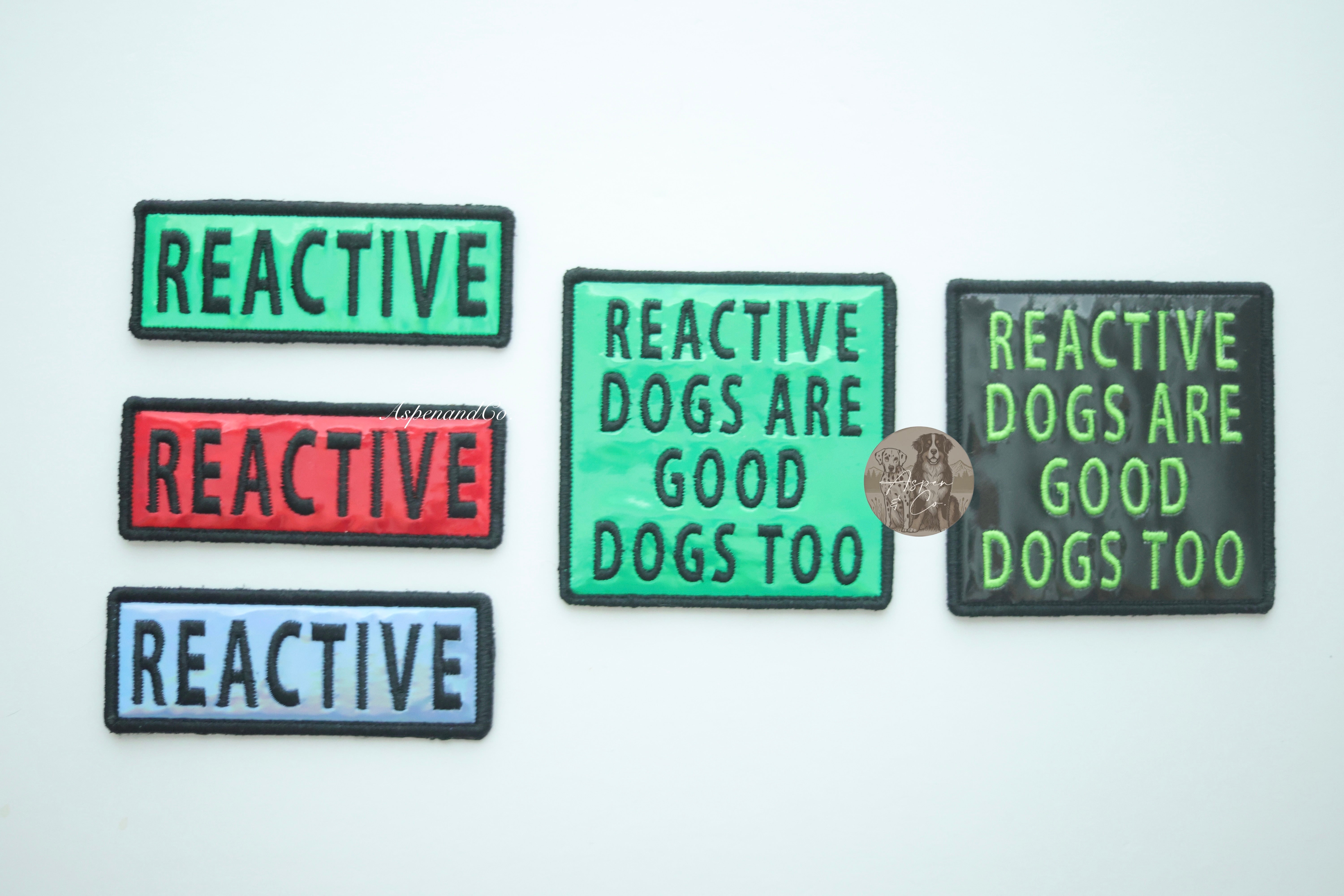 Photo showing available color options for holographic reactive dog patches: blue, green, red, and black.