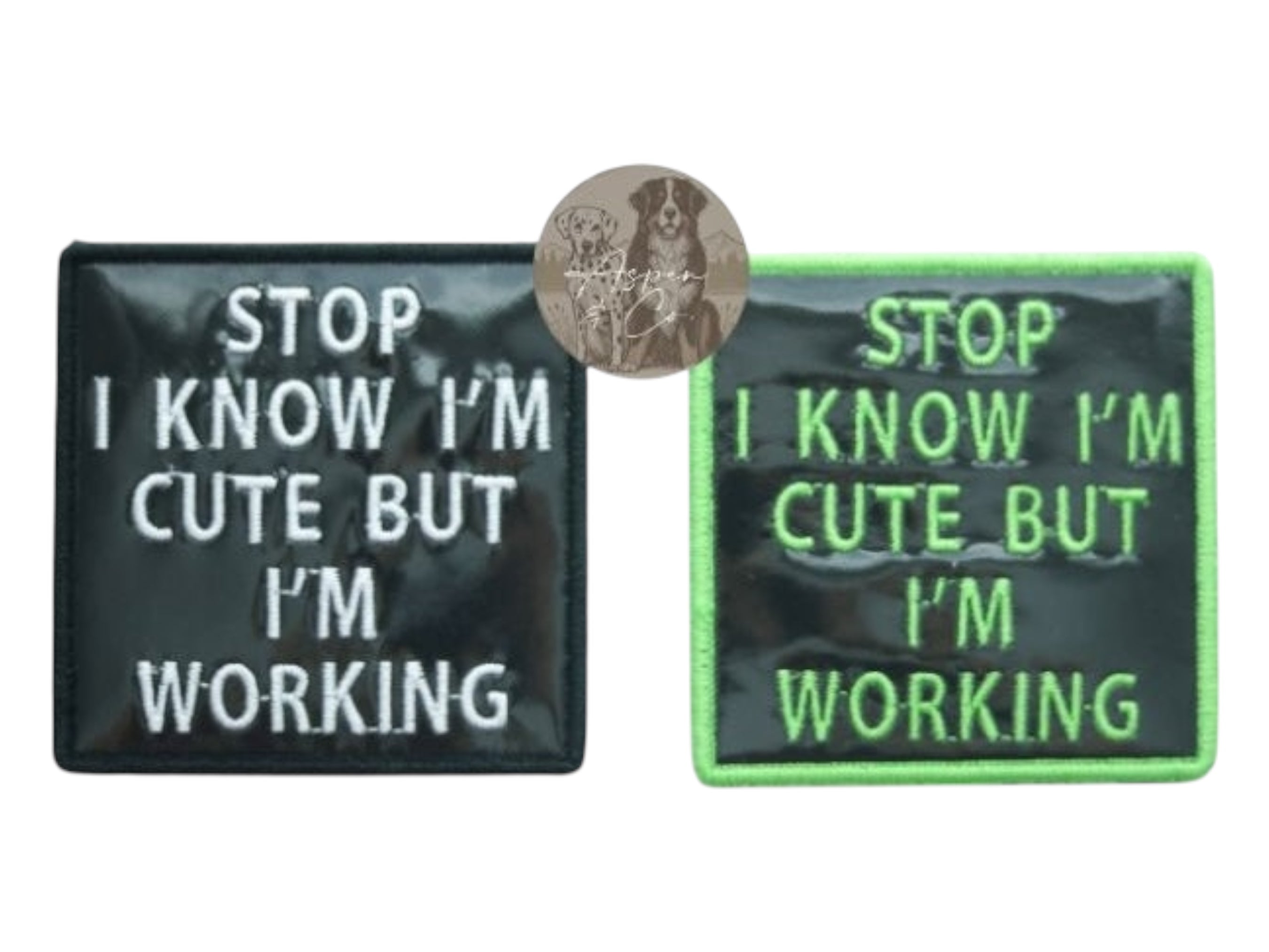 Black holographic dog patches with white text and with green text and green border, both saying "Stop I Know I'm Cute But I'm Working," designed for dog vests, harnesses, or capes.