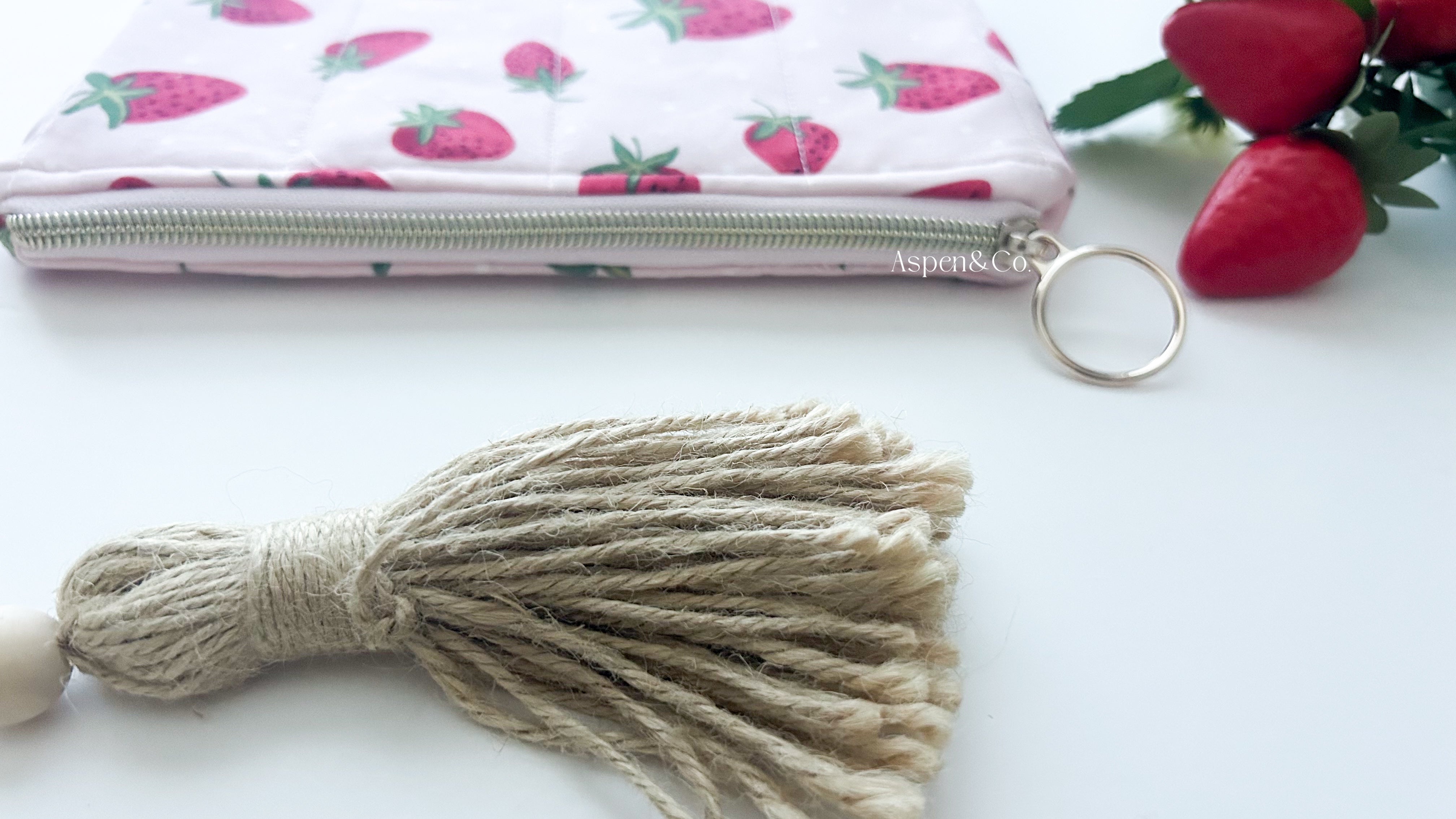 Handmade strawberry quilted book sleeve with zipper, pink fabric pouch for e-readers, hardcovers paperbacks - close up of gold zipper